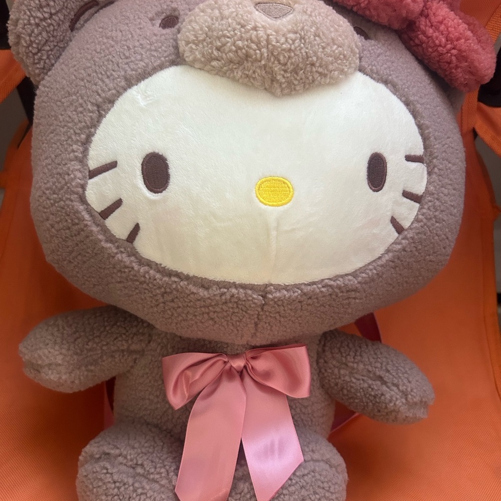 Cute Brown and pink hello kitty in a bear costume with Pink Bow